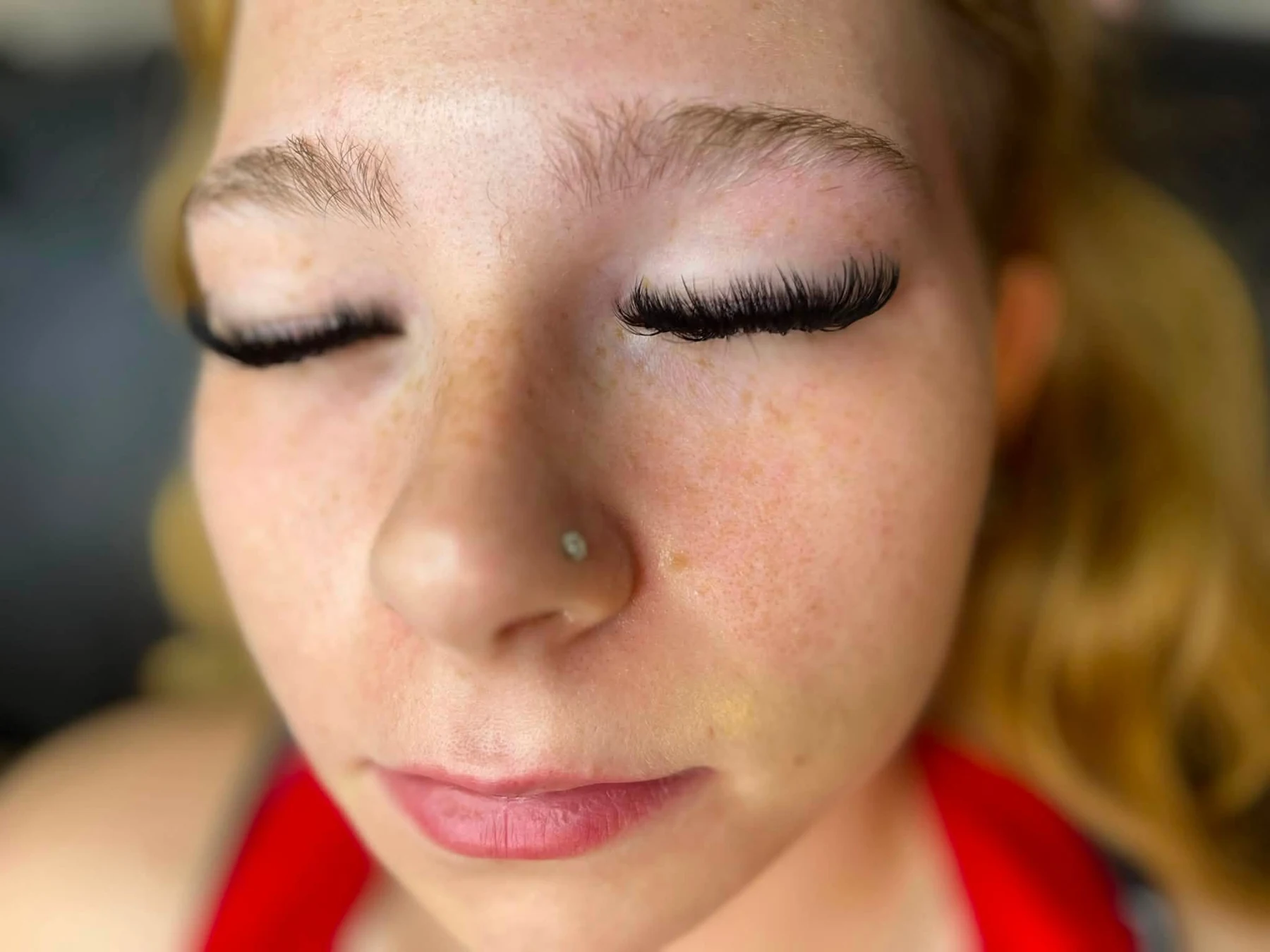 A Lash Bomb KC client showing the soft curl of her finished lashes with her eyes closed