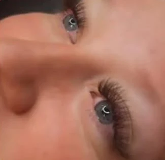 A Lash Bomb KC client showing her lash extensions